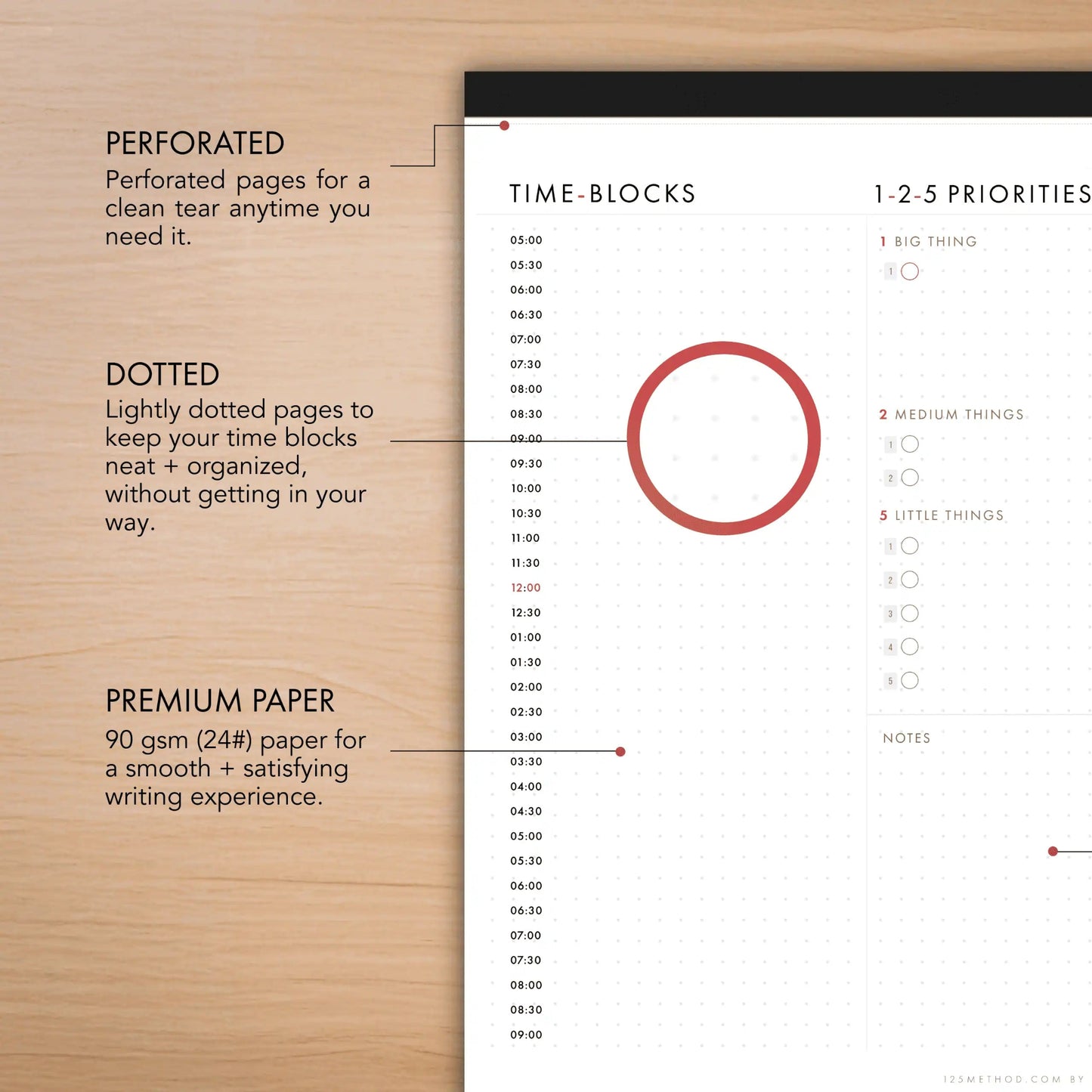 Time-blocking planner with priority system on a wooden surface