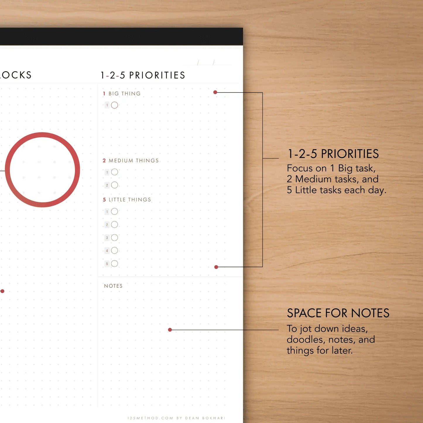 Time-blocking planner with priority system on a wooden surface