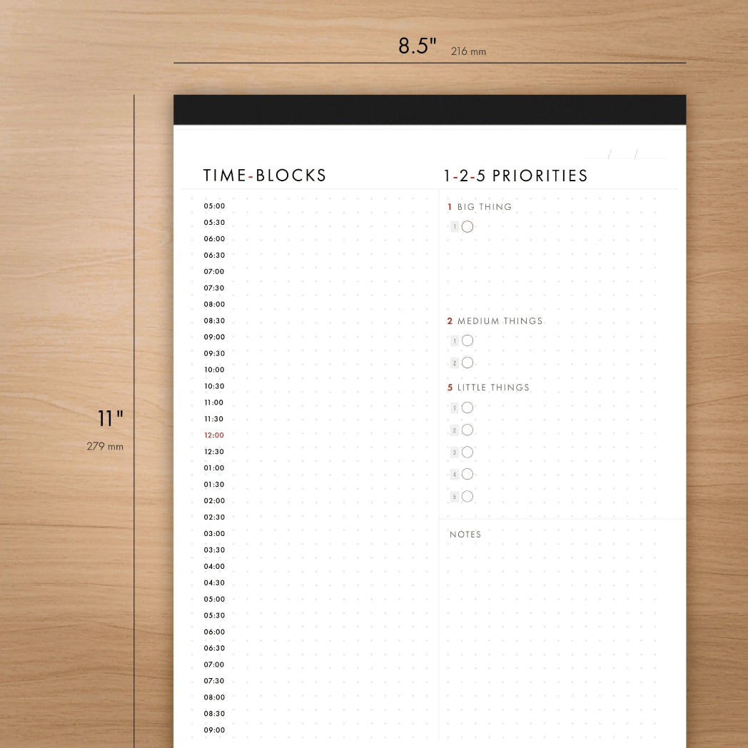 Time-blocks and priorities planner sheet on a wooden surface