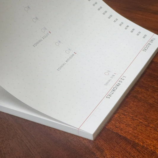 Open planner on a wooden surface