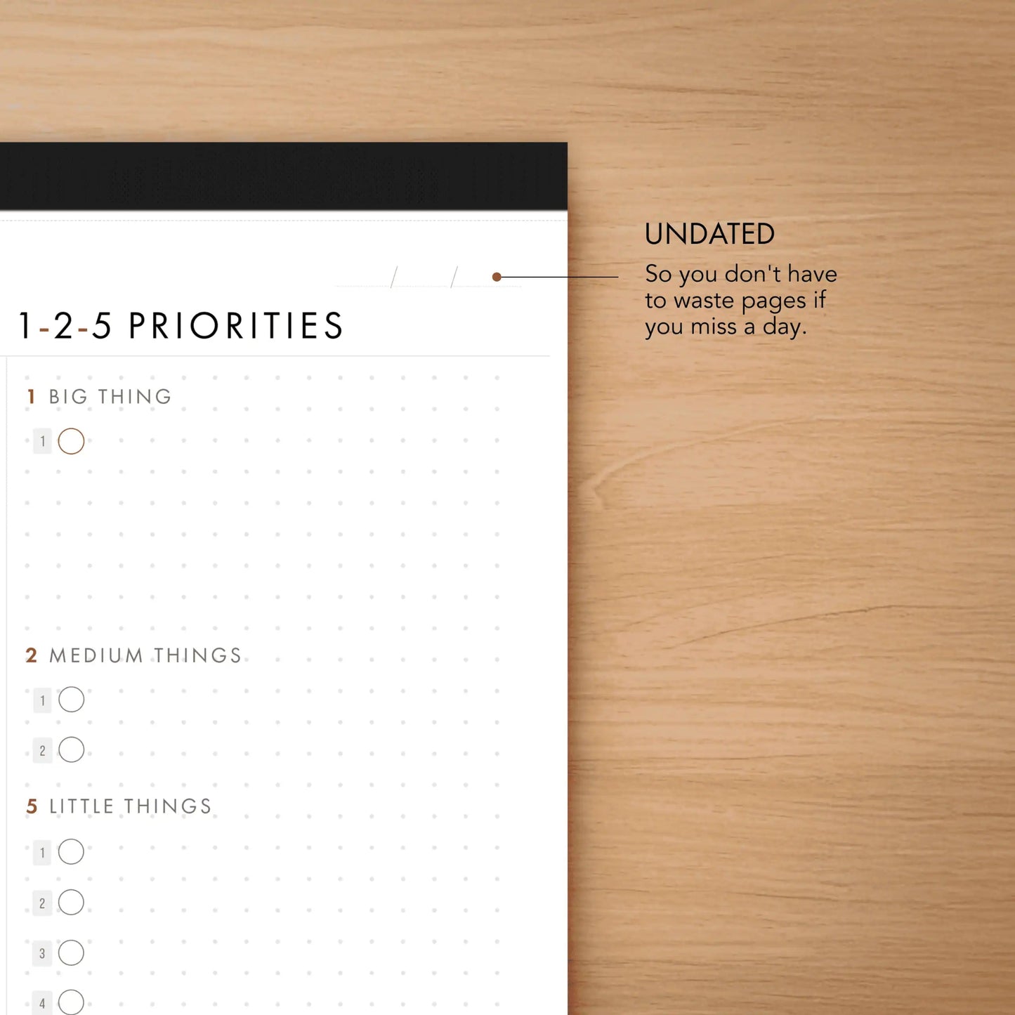 Time-blocks and priorities planner on a wooden surface