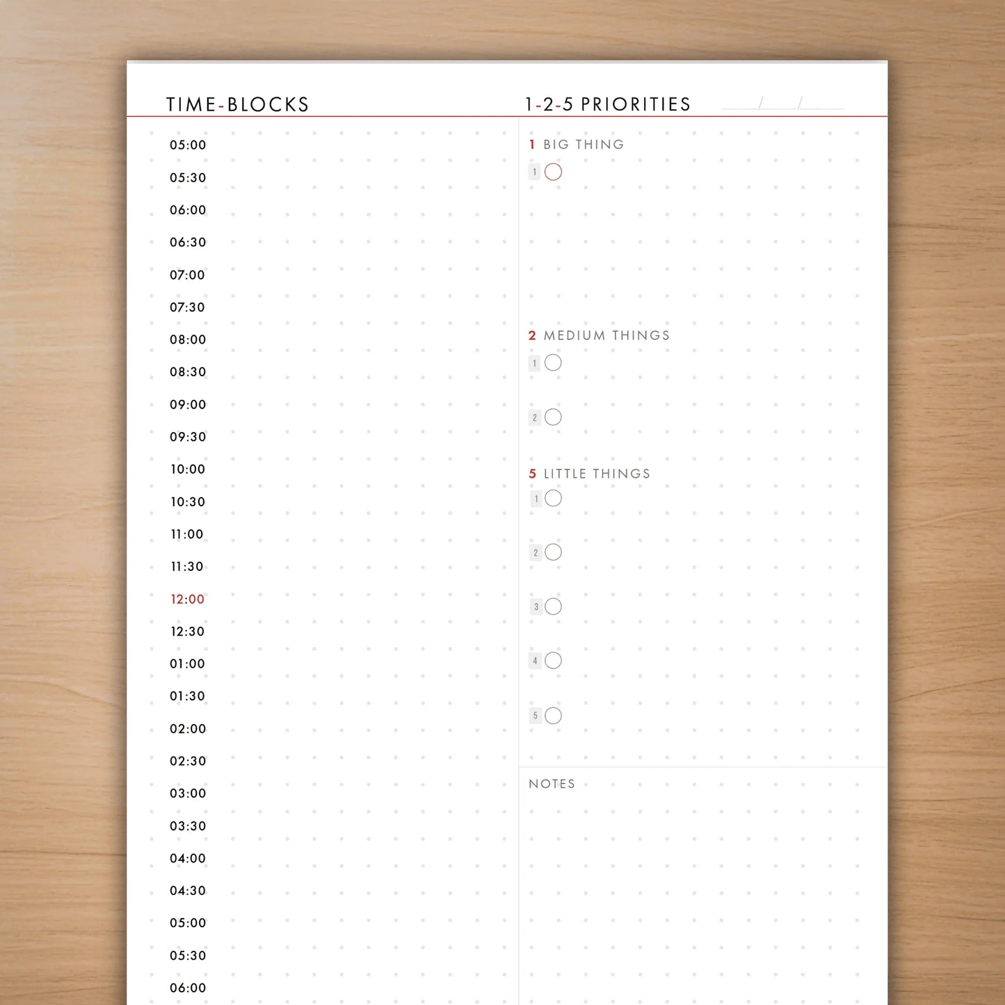Time-blocks and priorities sheet on a wooden surface