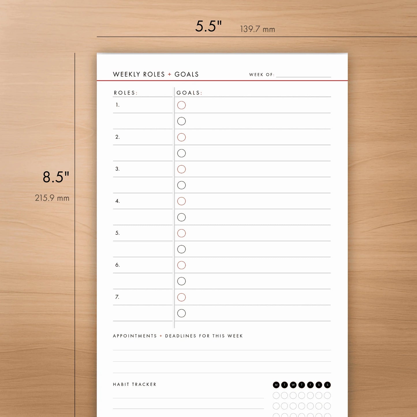Weekly roles and goals planning pad on a wooden surface with dimensions indicated.