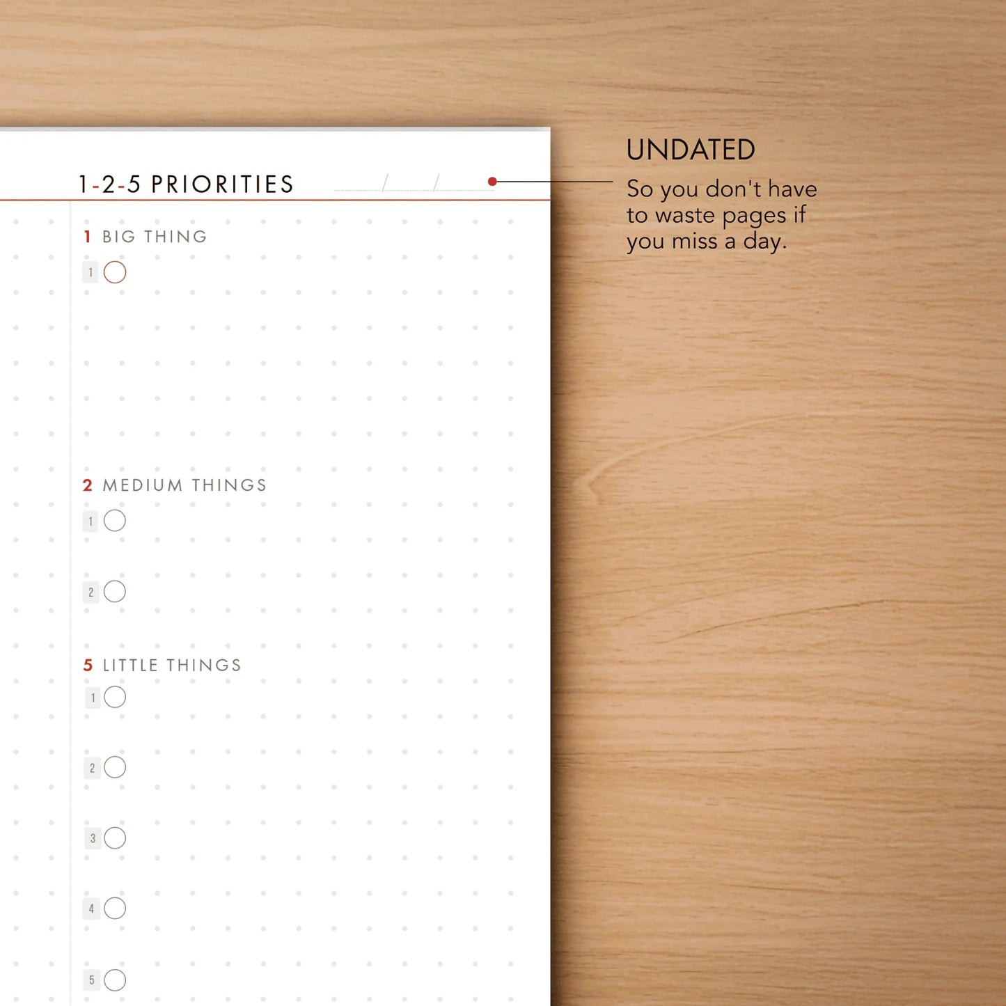 Notebook with a priority list on a wooden surface