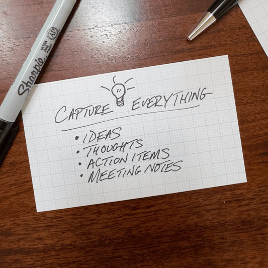 Capture Cards on a wooden surface with 'Capture Everything' text and a Sharpie marker.