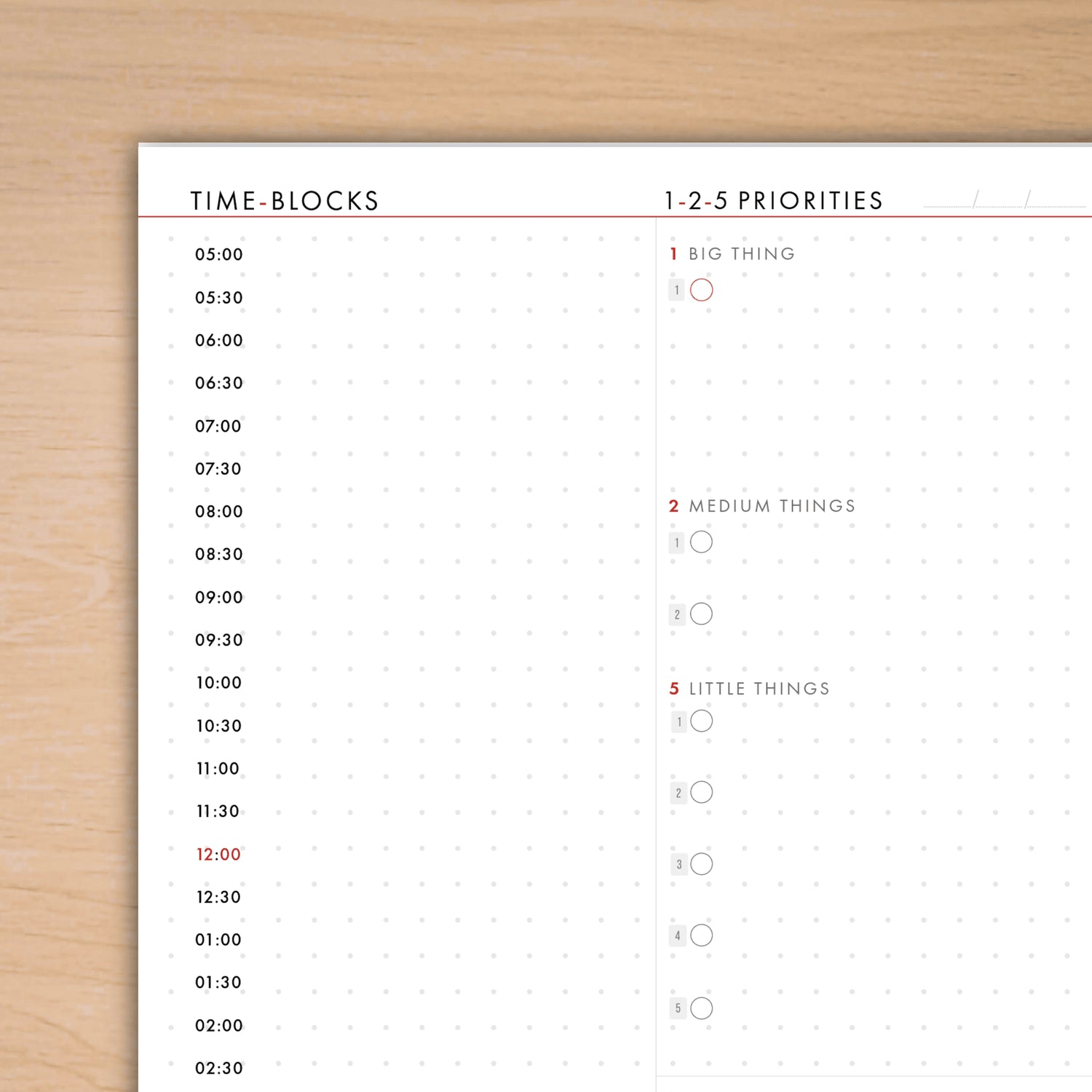 Time-blocks and priorities sheet on a wooden surface
