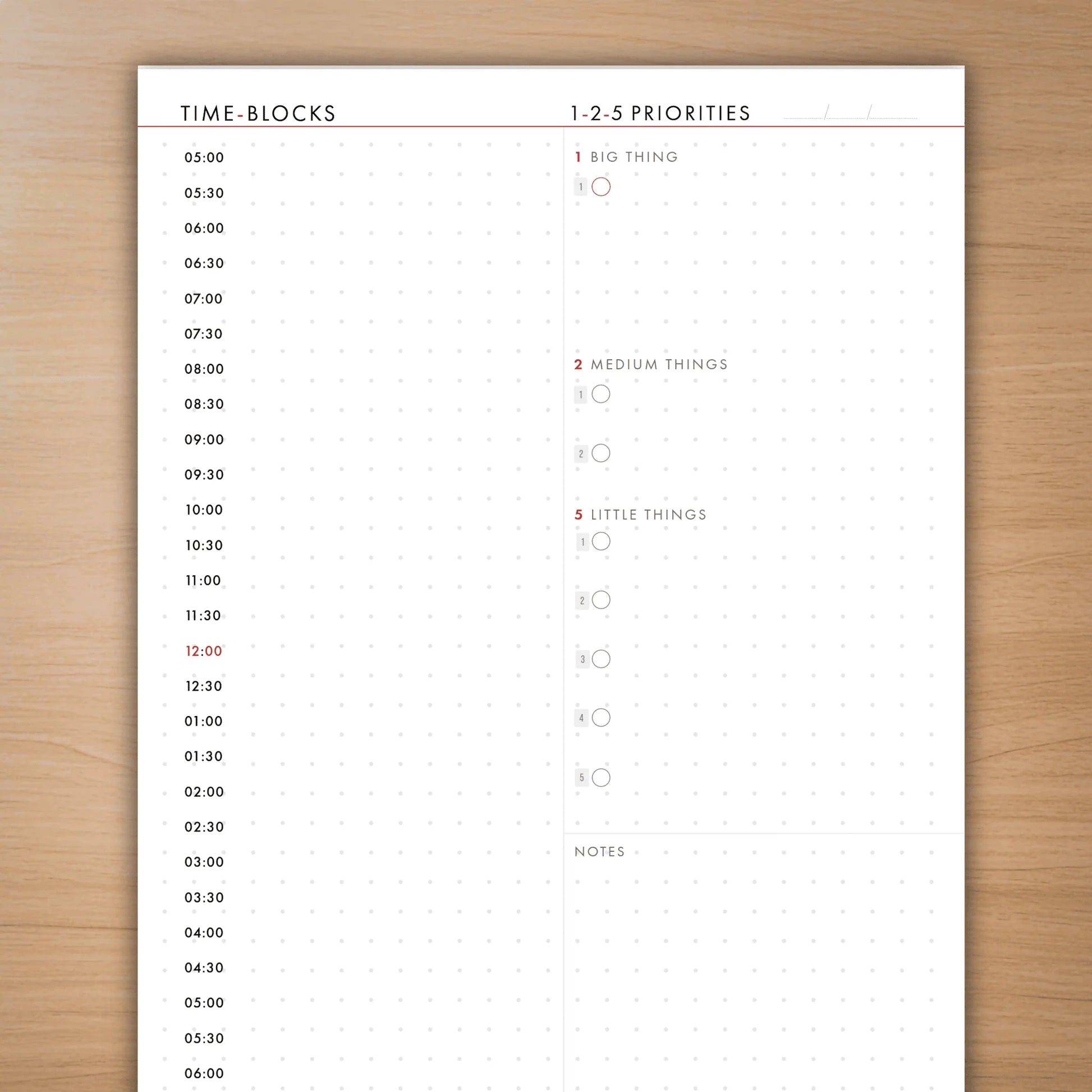 Time-blocks and priorities sheet on a wooden surface