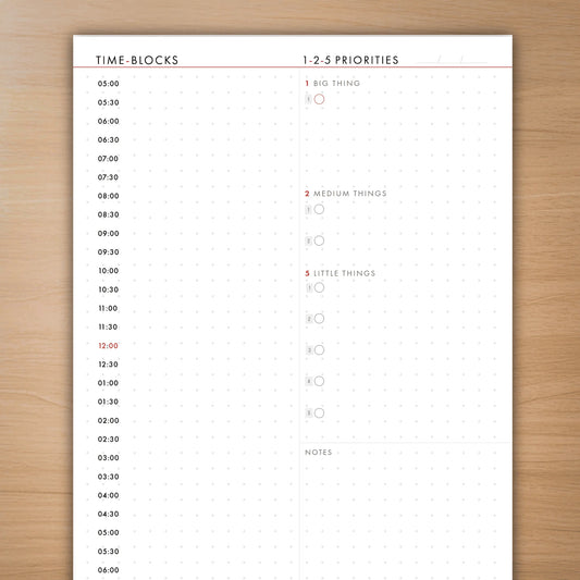 Time-blocks and priorities sheet on a wooden surface