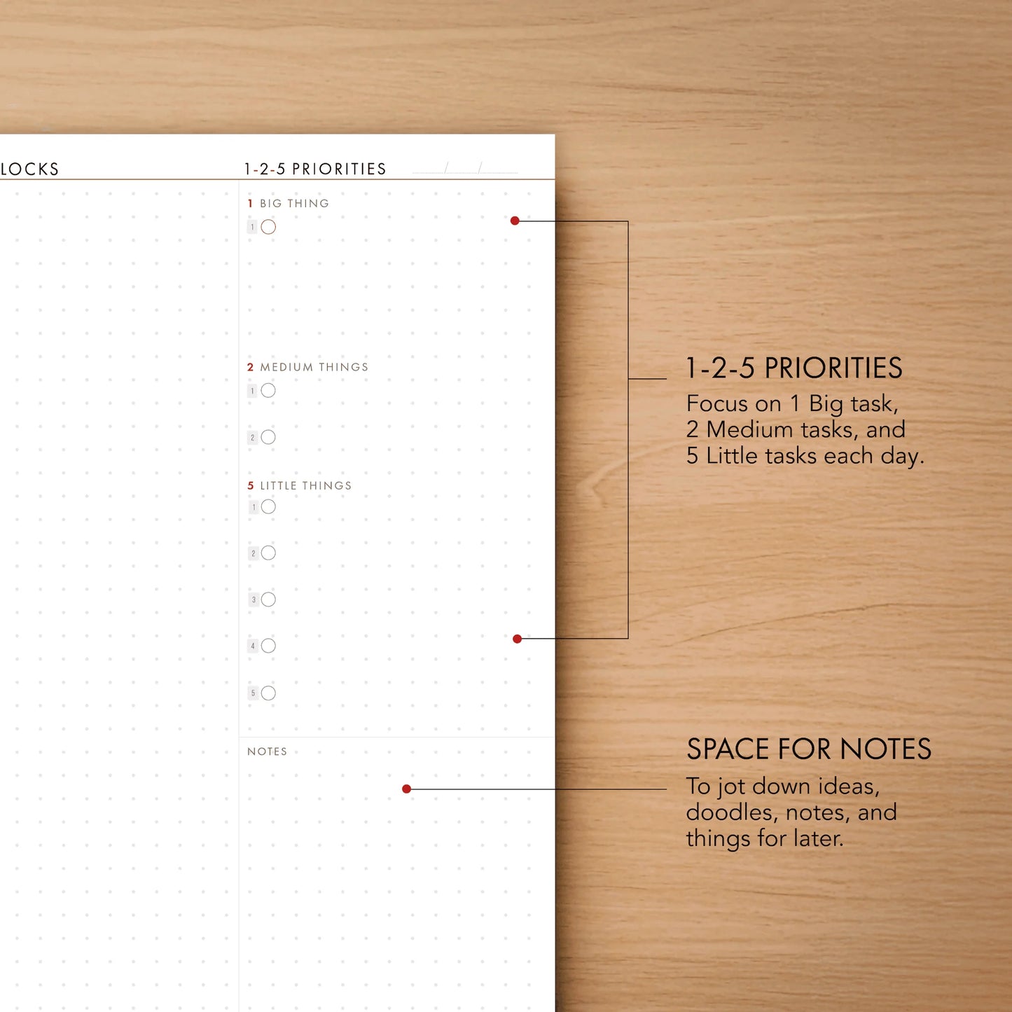 Task management sheet with priority levels on a wooden surface