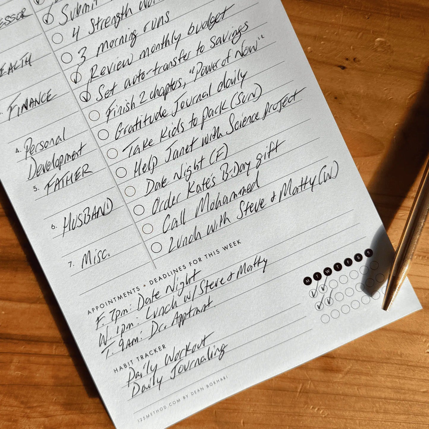 Weekly Planning Pad Handwritten to-do list on a wooden surface with a pen.