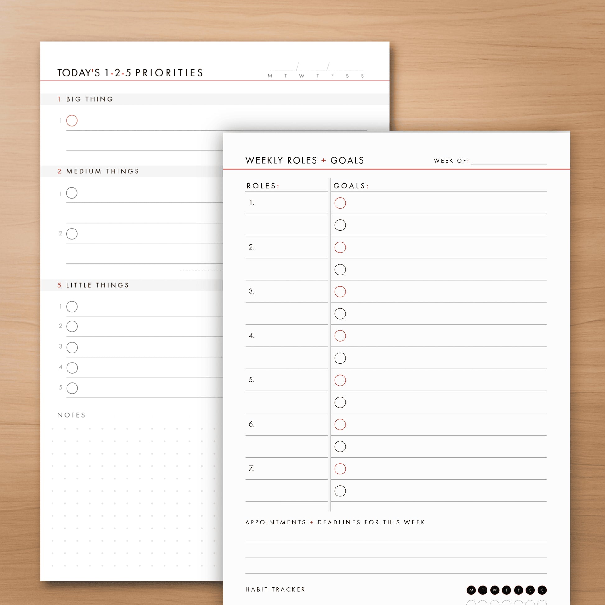 Two planner notepads on a wooden surface, one titled 'Today's 1-2-5 Priorities' and the other 'Weekly Roles + Goals'.